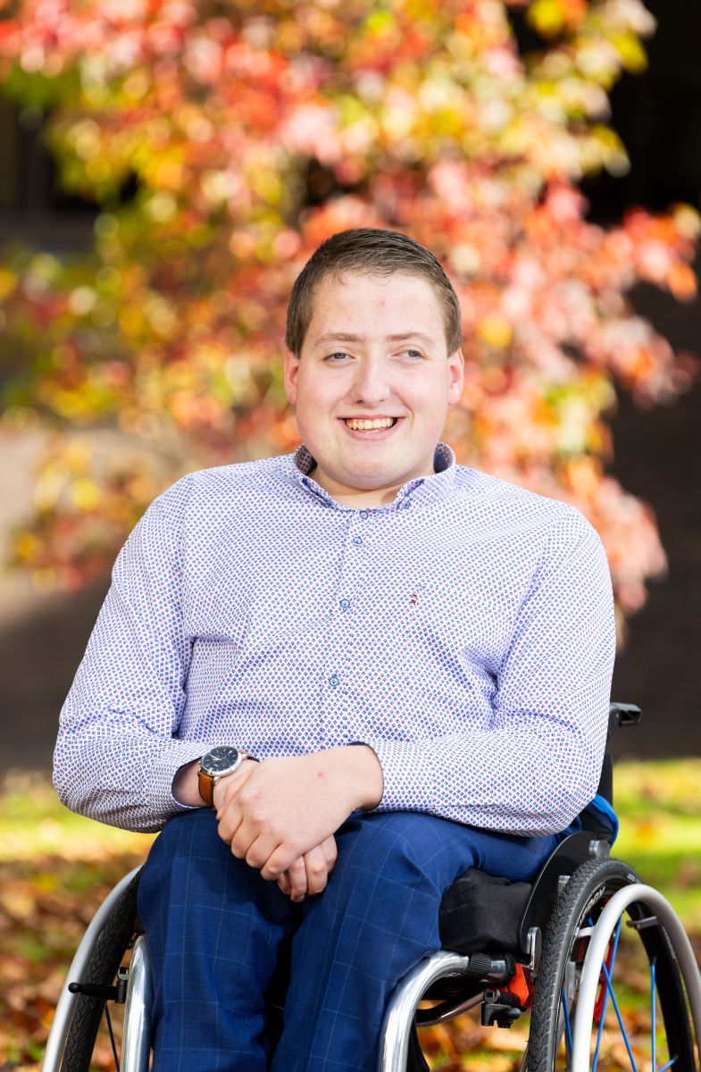 A photograph of Sean. He is smiling at the camera