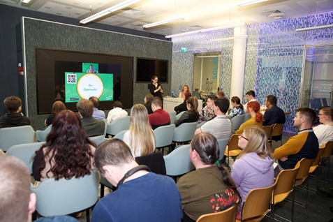 Image from the back of the room of graduates attending workshops