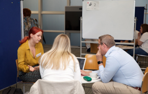 A graduate being interviewed by two employers